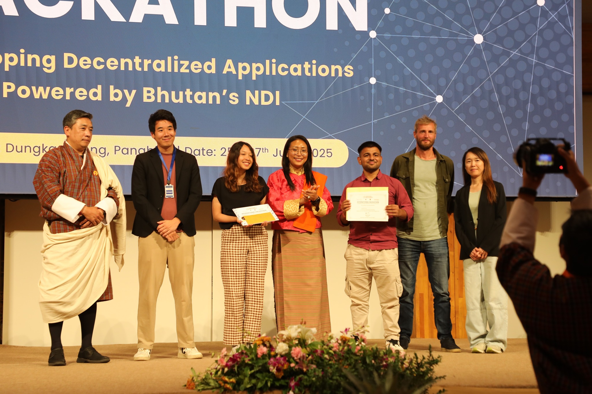 Team DeepGov on stage receiving the hackathon prize — Mapping Decentralized Applications Powered by Bhutan’s NDI, June 2025.